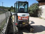 a small tractor that is parked on the side of the road