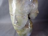 a close up of a vase with a face on it