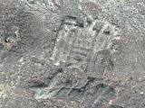 an image of a rock with a cross carved into it
