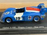 a model of a blue race car in a display case