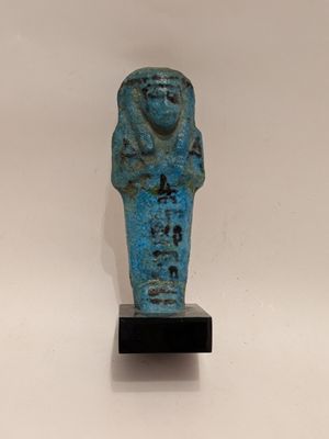 an egyptian statue of a man with a blue body on a black base