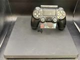 a video game controller sitting on top of a metal box