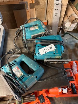 several electric tools are sitting on a table in a workshop