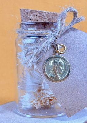 a small glass jar with a coin in it on a table