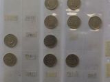 a lot of coins that are on display in a glass case