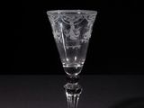 a close up of a wine glass on a table with a black background