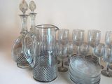 many glasses and a pitcher sitting on a table