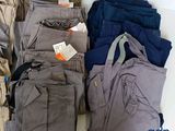 many different colored pants on a white table