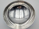 silver plated bowl on a white surface with a silver handle