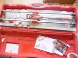 a red tool case with tools in it sitting on the floor