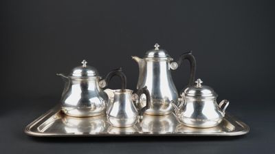 a silver tray with a silver tea set on it