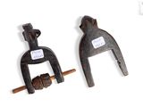 pair of old rusty pipe clamps on a white background
