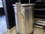 a large pot that is sitting on the floor in the kitchen
