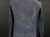 the back view of a blue jacket on a mannequin stand