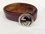 a close up of a brown belt with a silver buckle