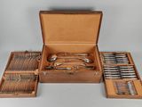 a wooden box with silverware in it on a table