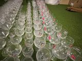 a lot of empty wine glasses sitting on the floor