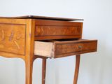 a small wooden table with a drawer on top of it
