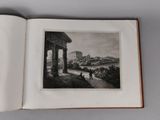 an open book with a picture of a city in the background