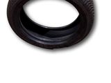an image of a tire on a white background with a sticker on it