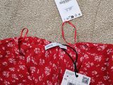 a close up of a red dress with a price tag on it