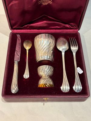 silverware in a red case on a white table