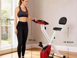 the woman is standing next to an exercise bike in the living room