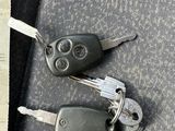 two keys that are laying on the seat of a car
