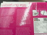 a pink box with a picture of an egg inside of it