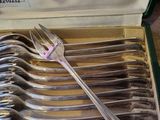 a lot of forks in a box on the table