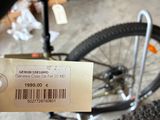 a person holding a bike with a price tag on it