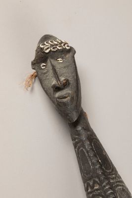 une sculpture en bois représentant un homme coiffé d'un chapeau