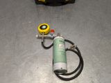 a hose and a canister on the floor next to it