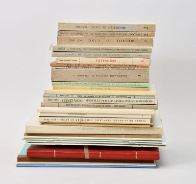 many books stacked on top of each other on a table