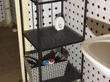 a black and white tiled bathroom with a sink and a shelf
