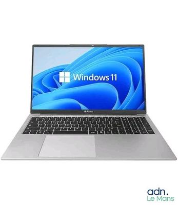 the laptop is open on a white surface with windows 11 logo on the screen