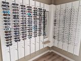 many pairs of sunglasses on display in a store