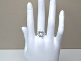 a white mannequin hand with a diamond ring on it
