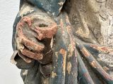 a statue of a man holding a flower in his hand