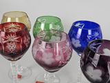 four wine glasses sitting next to each other on a table