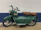 a green motorcycle that is parked in a garage