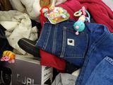 a pile of clothes and stuffed animals in a suitcase