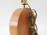 a wooden lamp that has a cord attached to it