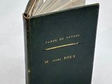 an old book sitting on top of a white table next to a white table