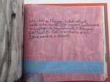 an open book with writing on it sitting on a table
