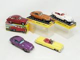 four toy cars that are on display in a display case