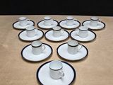 many cups and saucers on the table ready to be served