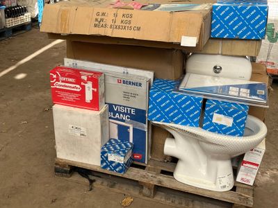 a white toilet sitting on top of a pallet in a warehouse