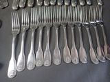 a lot of forks and spoons that are on a table