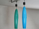 two blue and green lights hanging from the ceiling